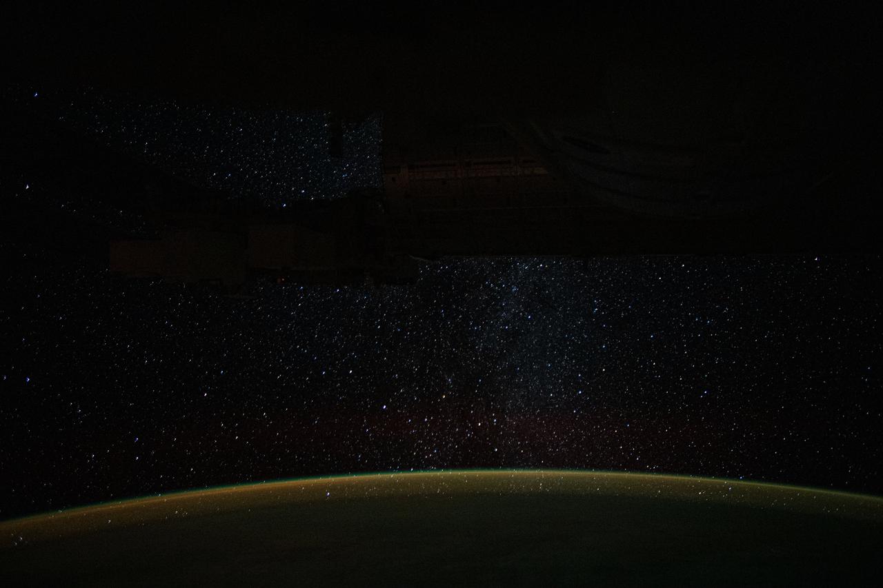 iss060e002064 (June 29, 2019) -- A starry Milky Way glitters above Earth's tranquil atmospheric glow as the International Space Station orbited 266 miles above the Pacific Ocean off the northwest coast of New Zealand.