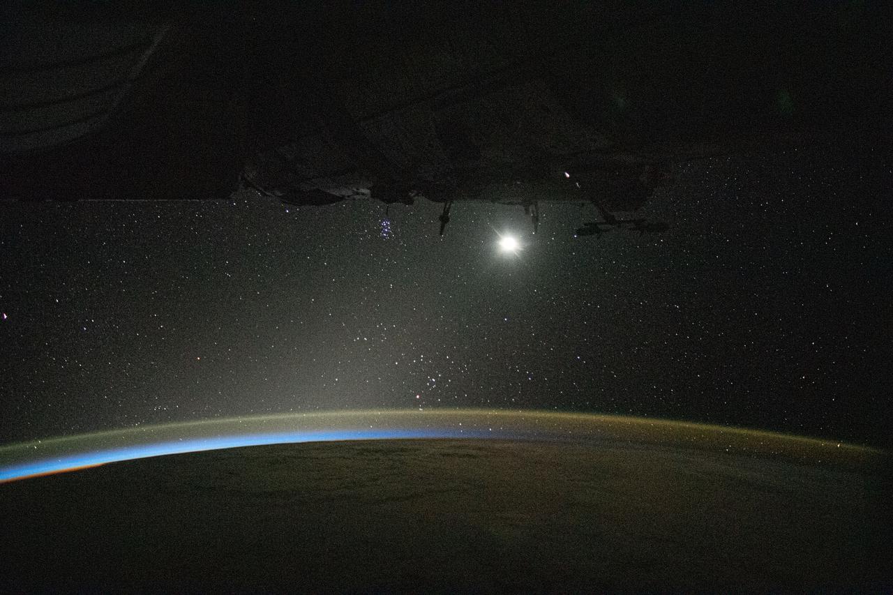 iss060e002090 (June 29, 2019) --- The Earth's limb and the atmospheric glow highlight the thin blue atmosphere back lit by the Sun's rays during a period between night and day. The light of the moon and the starry Milky Way drape the background as the International Space Station orbited 257 miles above the Pacific Ocean between Hawaii and Mexico.
