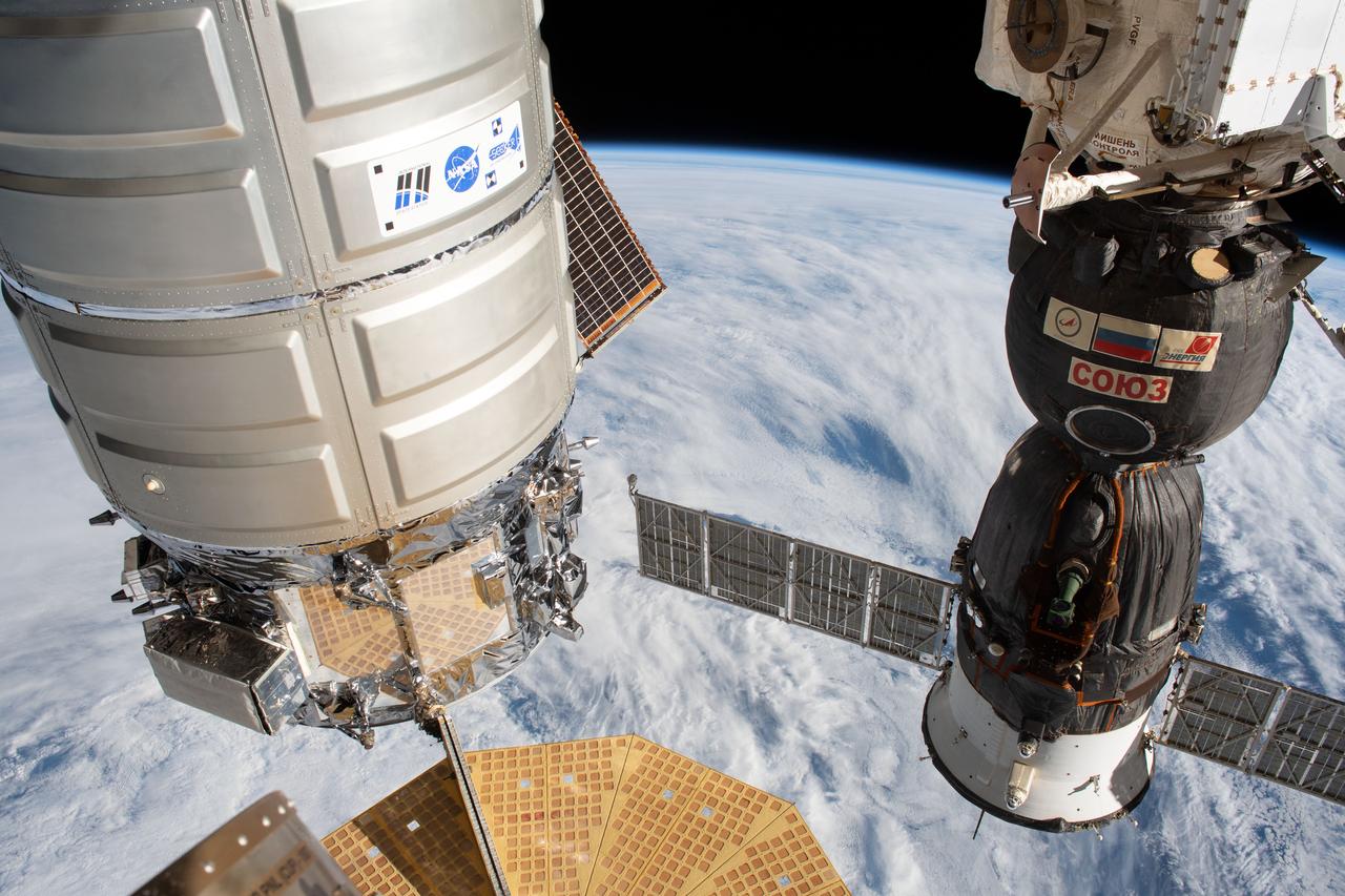 iss060e007341 (July 7, 2019) --- U.S. and Russian spaceships are pictured docked to the International Space Station as the orbiting laboratory flew 267 miles above the Pacific Ocean off the coast of Chile. From left is the Northrop Grumman Cygnus resupply ship attached to the Harmony module and the Soyuz MS-12 crew ship docked to the Rassvet module.
