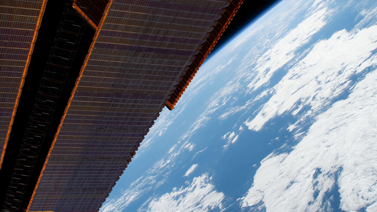 iss060e013819 (July 21, 2019) --- A portion of the International Space Station's main solar arrays drape the foreground as the orbiting lab flew 261 miles above the Pacific Ocean west of Peru.