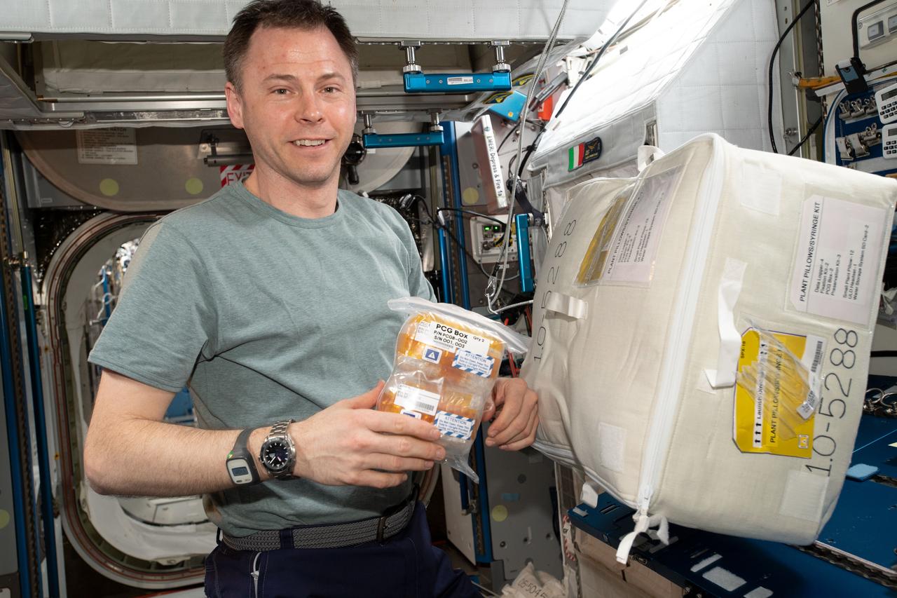 iss060e015014 (7/28/2019) — NASA astronaut Nick Hague is shown holding the CASIS Protein Crystal Growth 15 (CASIS PCG 15) investigation samples aboard the International Space Station (ISS). Microgravity Crystal Growth for Improvement in Neutron Diffraction and the Analysis of Protein Complexes (CASIS PCG 15) seeks a better understanding of enzyme catalysis by examining crystals from two model Pyridoxal phosphate (PLP) dependent enzymes and from a bacteriophage transient deoxyribonucleic acid (DNA) repair complex. Analysis of the crystals may reveal catalyst mechanisms and structures and visualize the interaction between the repair proteins. Results could contribute to identification of biomarkers for diagnosis of disease and to development of better antimicrobials.