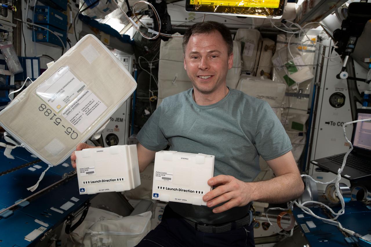 iss060e015022 (7/28/2019) — NASA astronaut Nick Hague is shown holding the Perfect Crystals investigation samples within Styrofoam containers in Node 3 aboard the International Space Station (ISS). Growth of Large, Perfect Protein Crystals for Neutron Crystallography (Perfect Crystals) crystallizes human manganese superoxide dismutase in order to analyze its shape. This sheds light on how the antioxidant protein helps protect the human body from oxidizing radiation and oxides created as a byproduct of metabolism.