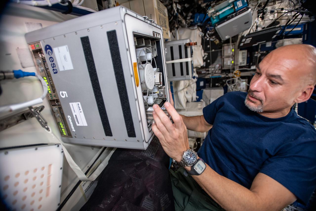 iss060e019706 (7/30/2019) --- European Space Agency (ESA) astronaut Luca Parmitano during Biorock Experiment Containers installation in KUBIK in the Columbus Module. The Biorock investigation is expected to help gain additional insight into the physical interactions of liquid, rocks, and microorganisms under microgravity conditions for novel acquisition of materials in space. In addition, data from Biorock can be used to inform the development of life support systems involving microbial components on long-duration spaceflight missions.