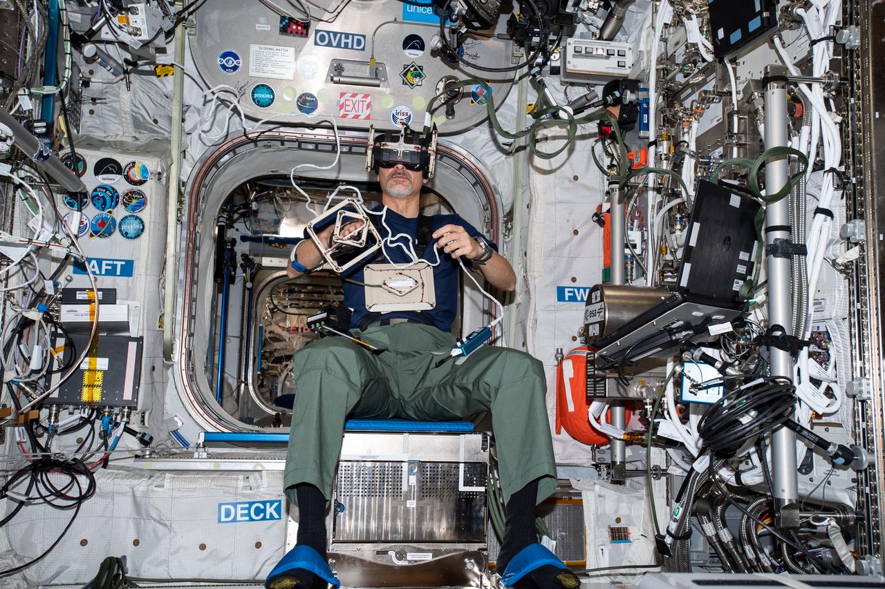 iss060e021138 (Aug. 1, 2019) --- Expedition 60 Flight Engineer Luca Parmitano of the European Space Agency (ESA) is seated inside ESA's Columbus laboratory module wearing virtual reality goggles exploring how microgravity affects an astronauts ability to grip and manipulate objects. The ESA GRIP study may inform the design of future spacecraft control devices and space system interfaces.