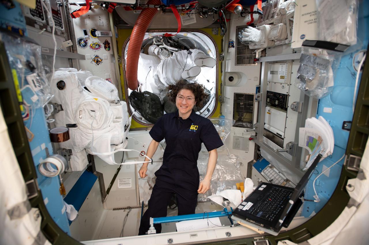iss060e029526 (Aug. 8, 2019) --- Expedition 60 Flight Engineer Christina Koch of NASA works inside the U.S. Quest airlock configuring a pair spacesuits that NASA astronauts Nick Hague and Andrew Morgan will wear during a spacewalk on Aug. 21. The duo will spend about six and a half hours routing cables and configuring the International Docking Adapter-3 on top of the Harmony module in preparation for the arrival of future SpaceX and Boeing crew vehicles.