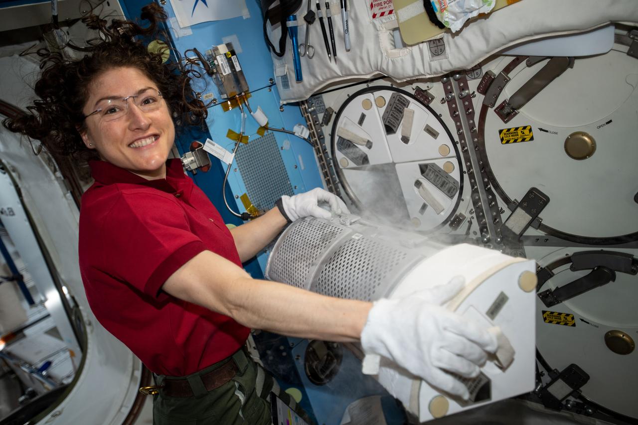 iss060e035160 (Aug. 12, 2019) --- Expedition 60 Flight Engineer Christina Koch of NASA conducts science operations inside Japan's Kibo laboratory module with a science freezer that preserves biological research samples for later analysis.