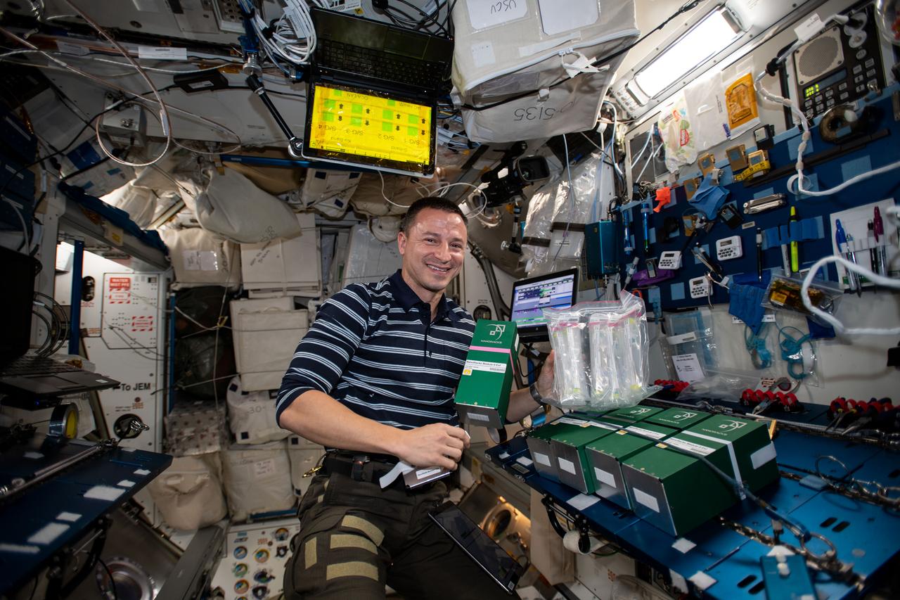 iss060e035415 8/13/2019) --- A view of NASA astronaut Drew Morgan during the deactivation and/or shaking designated mixture tubes of NanoRacks-NCESSE-Gemini NanoRacks-National Center for Earth and Space Science-Gemini (SSEP Mission 13) - Part of NanoRacks Module-9 Ext. aboard the International Space Station (ISS). The experiments range from examinations of water filtration and purification to synthetic soil production, rust formation, antibiotic effectiveness, growth and development of microacquatic organisms, and growth of plant, fungi, and bacteria. Each was chosen from more than 3,000 entries submitted by more than 23,000 U.S., Canadian, and Brazilian students. The experiments use NanoRacks MixStix, miniature laboratories activated by space station crew and eventually returned to the student teams on Earth for analysis.