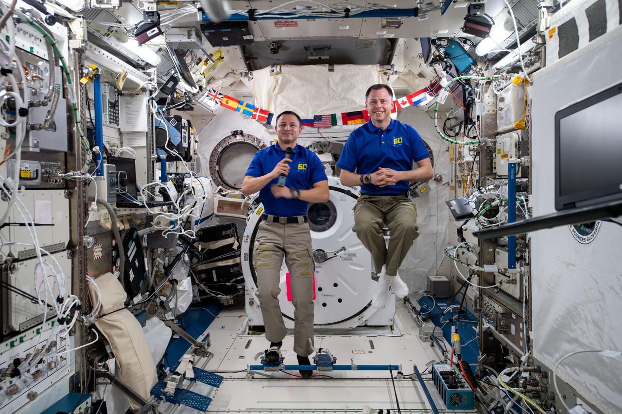 iss060e054187 -- Expedition 60 flight engineers Andrew Morgan and Nick Hague of NASA conduct in-flight interviews with television stations located in Pittsburgh, PA where they discuss what it's like living and working on the International Space Station.