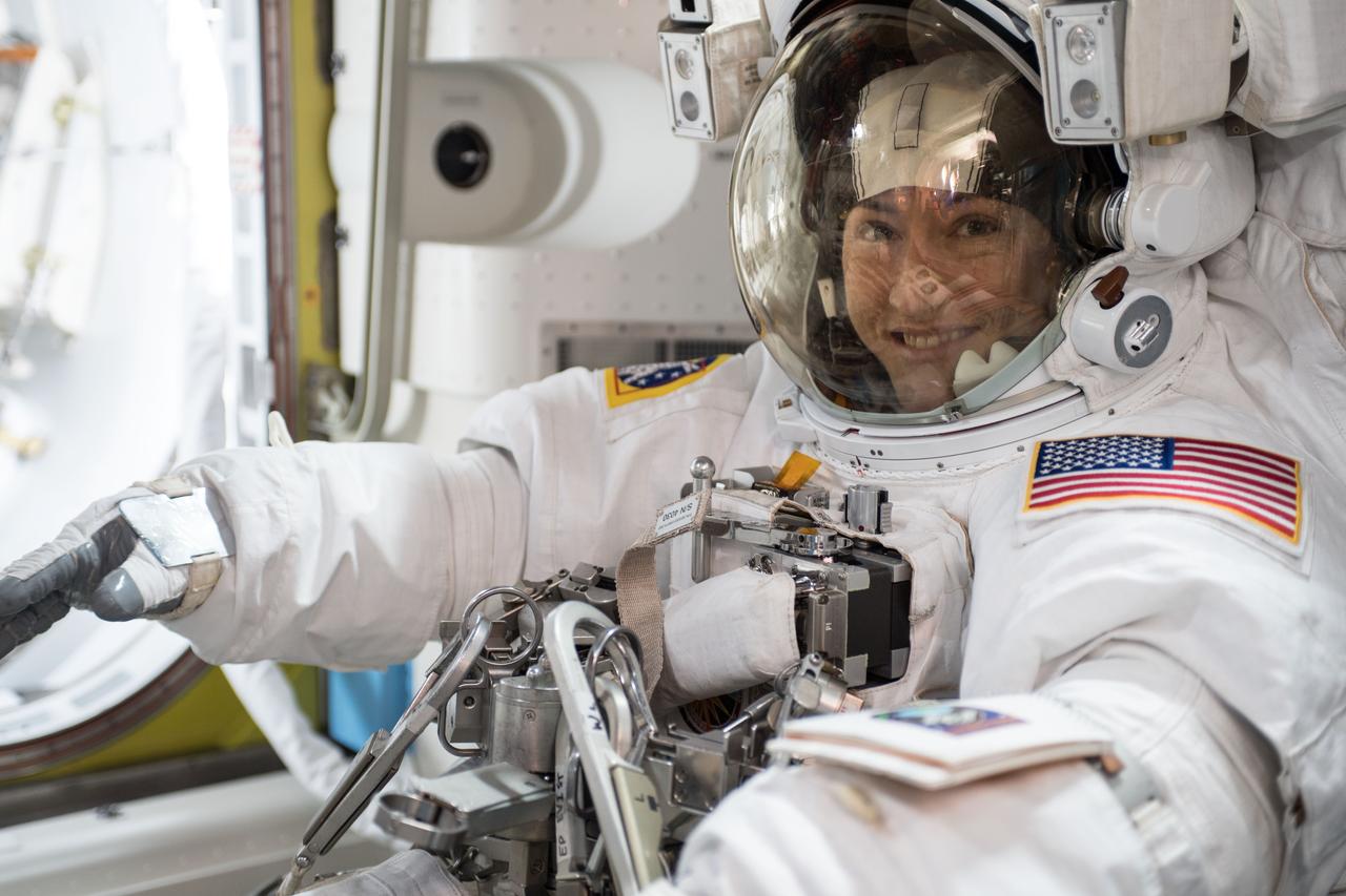 iss061e001614 (Oct. 6, 2019) --- NASA astronaut Christina Koch is suited up in a U.S. spacesuit before beginning a seven hour and one minute spacewalk to upgrade the station's large nickel-hydrogen batteries with newer, more powerful lithium-ion batteries.