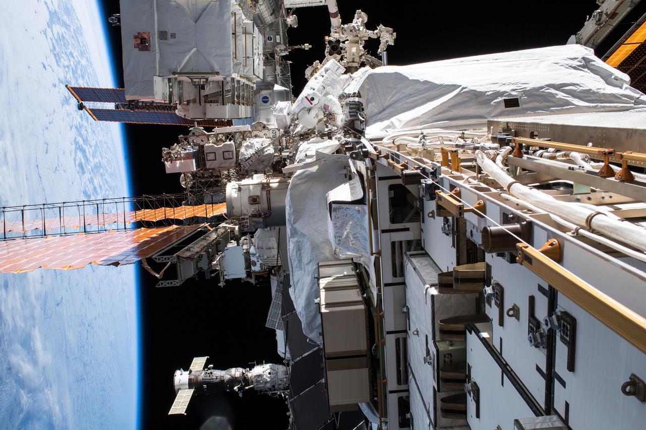 iss061e003327 (Oct. 6, 2019) --- NASA astronaut Christina Koch (top center) conducts a spacewalk at the Port-6 (P6) truss structure work site to upgrade International Space Station power systems. She and fellow NASA astronaut Andrew Morgan (out of frame) worked outside in the vacuum of space for seven hours and one minute to begin the latest round of upgrading the station's large nickel-hydrogen batteries with newer, more powerful lithium-ion batteries.