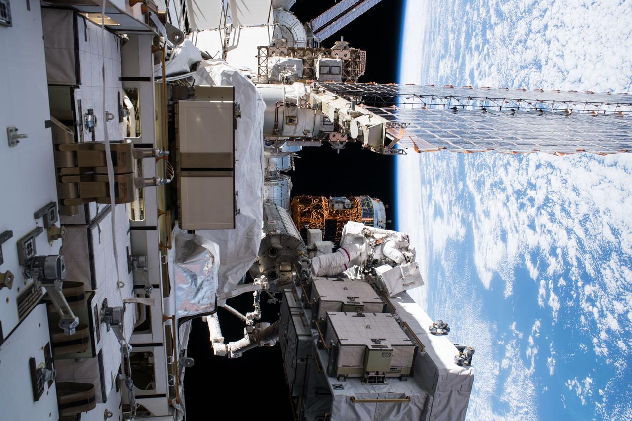 iss061e003491 (10/6/2019) --- A view of extravehicular crewmember 1 (EV1) Christina Koch on the Exposed Pallet (EP) during Extravehicular Activity 56 (EVA 56) cleanup operations (OPS). The Earth limb is in the background. Extravehicular activity (EVA) is any activity done by an astronaut or cosmonaut outside a spacecraft beyond the Earth's appreciable atmosphere. The term most commonly applies to a spacewalk made outside a craft orbiting Earth (such as the International Space Station).