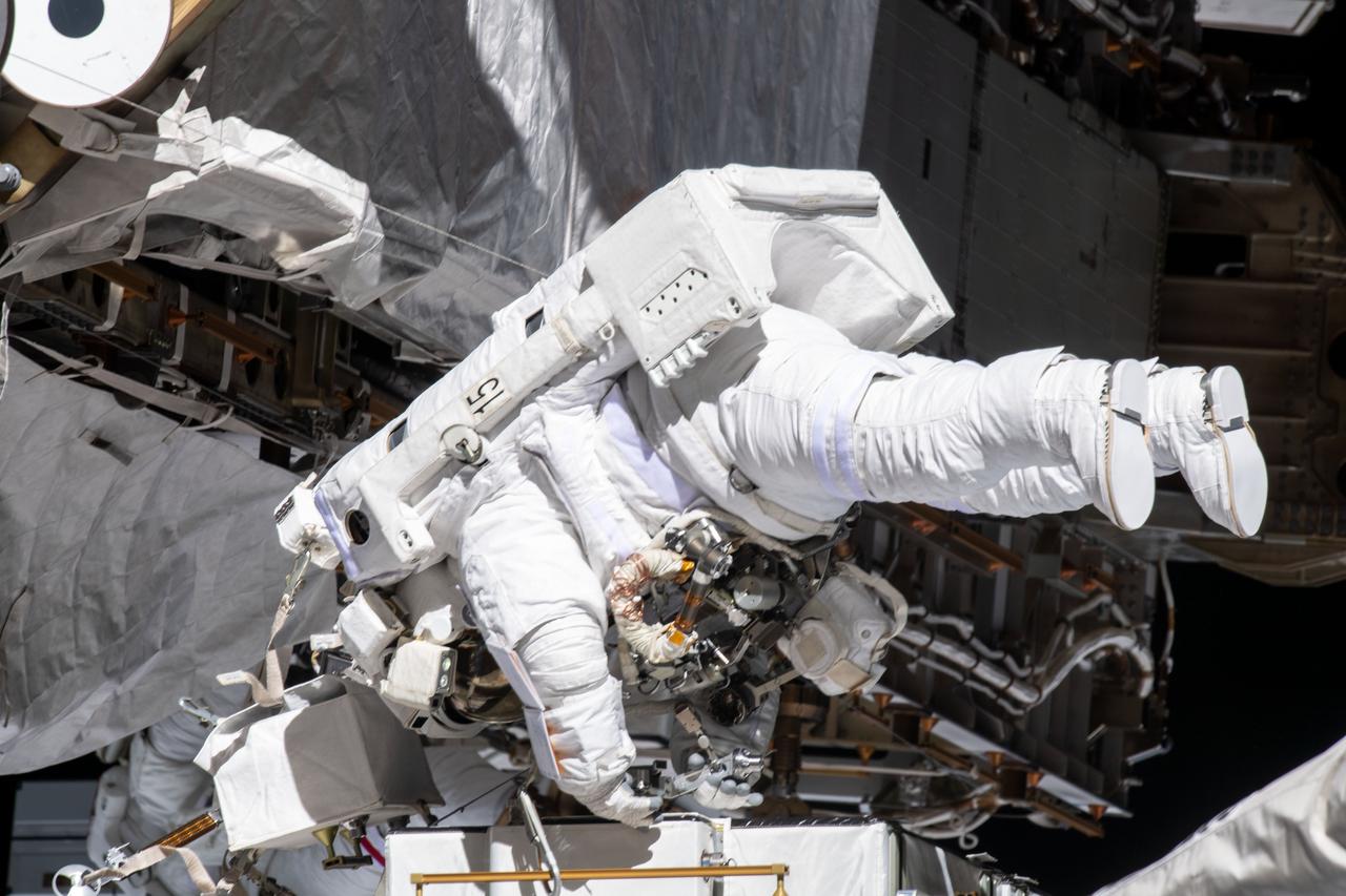 iss061e005311 (Oct. 11, 2019) --- NASA astronaut Christina Koch works while tethered near the Port 6 truss segment of the International Space Station to replace older hydrogen-nickel batteries with newer, more powerful lithium-ion batteries. Fellow NASA astronaut Andrew Morgan (out of frame) assisted Koch during the six-hour and 45-minute spacewalk.