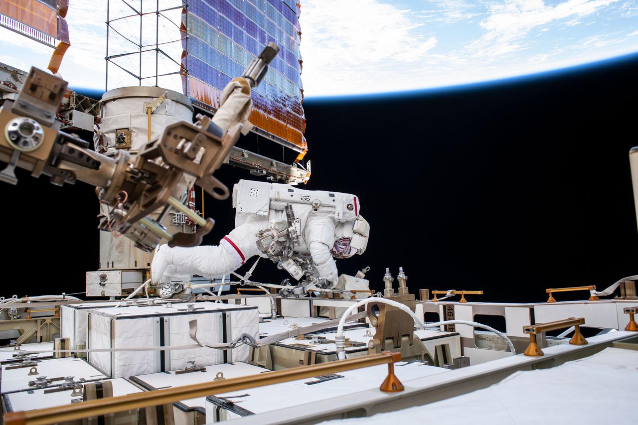 iss061e005542 (Oct. 11, 2019) --- NASA astronaut Andrew Morgan works while tethered on the Port 6 truss segment of the International Space Station to replace older hydrogen-nickel batteries with newer, more powerful lithium-ion batteries. The batteries store and distribute power collected from the station's basketball court-sized solar arrays, one of which is directly behind Morgan.