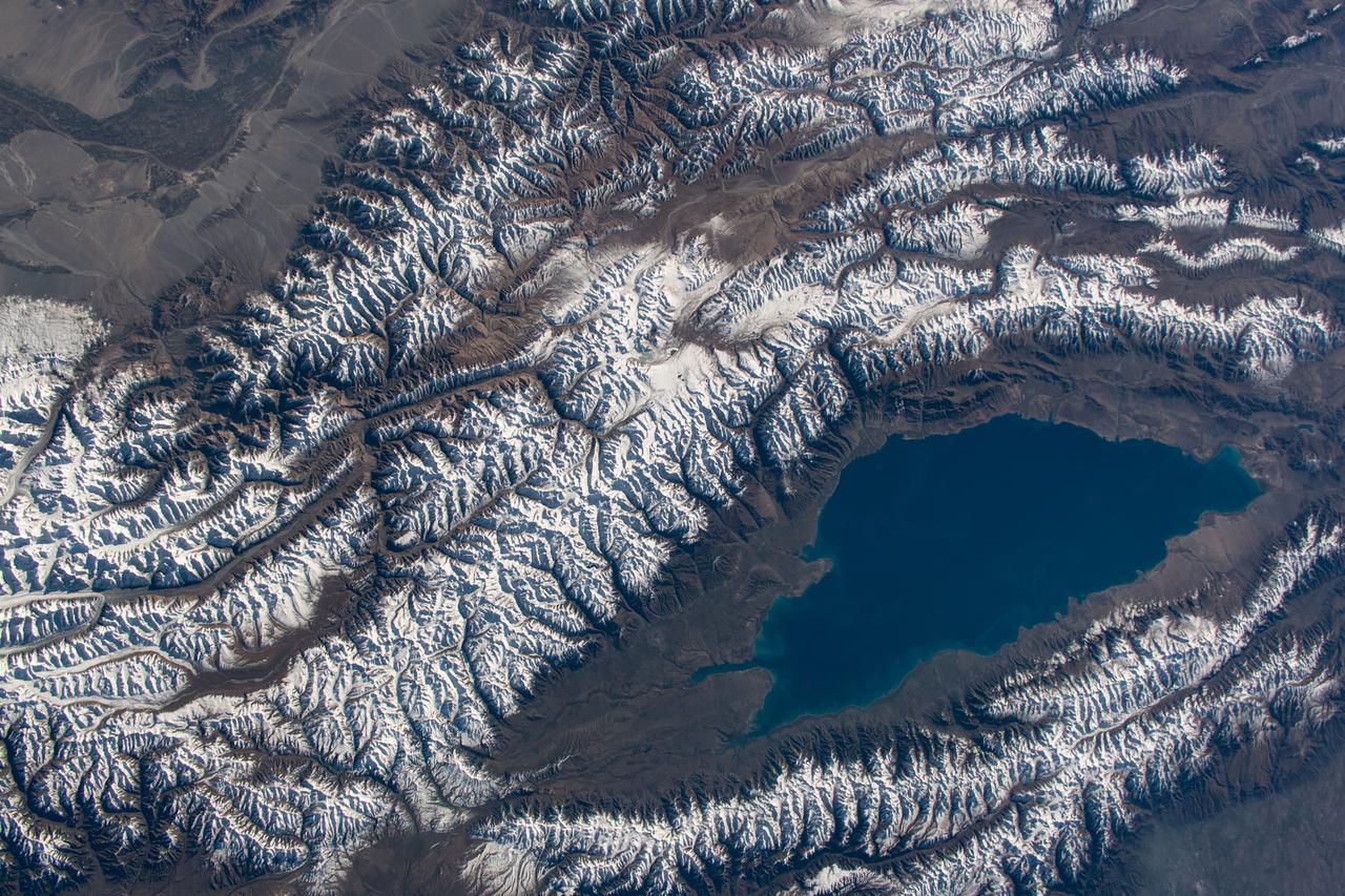 iss061e006705 (Oct. 16, 2019) --- Issyk-Kul Lake in the central Asian nation of Kyrgyzstan is surrounded by the snow-capped Tian Shen mountains. It is the second-largest mountain lake in the world behind Lake Titicaca in South America.  The International Space Station was orbiting 252 miles above southeastern Kazakhstan with a ground distance of 72 miles from Issykul-Lake when this photograph was taken.