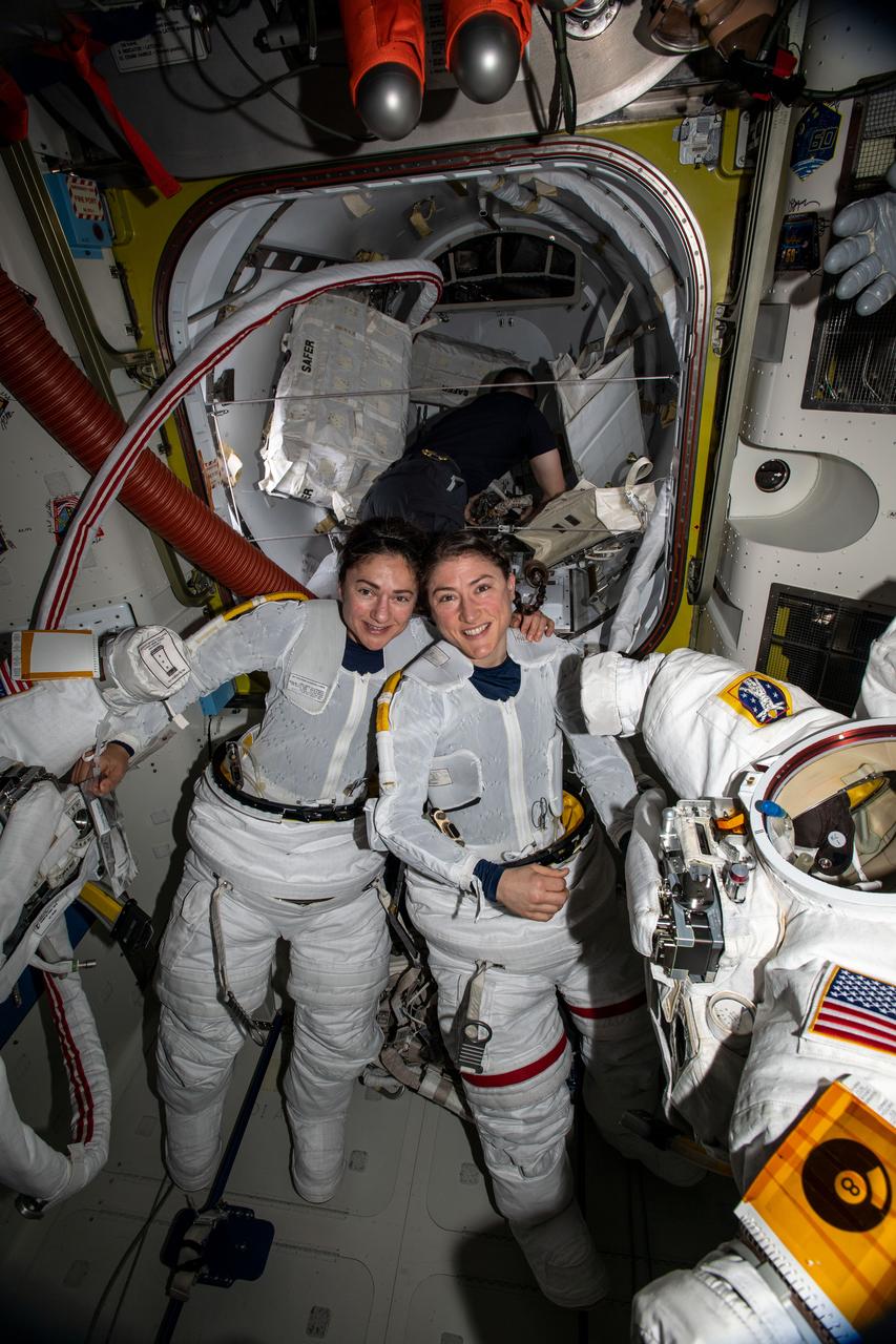 NASA astronauts Jessica Meir (left) and Christina Koch (right) put on their spacesuits as they prepare to leave the hatch of the International Space Station and begin the historical first-ever all-female spacewalk. The two ventured outside the International Space Station on Friday, Oct. 18, to replace faulty equipment on the station’s exterior. The astronauts replaced a faulty battery charge/discharge unit (BCDU) that failed to activate following the Oct. 11 installation of new lithium-ion batteries on the space station’s exterior structure. The BCDUs regulate the amount of charge put into the batteries that collect energy from the station’s solar arrays to power station systems during periods when the station orbits during nighttime passes around Earth. Though the BCDU failure has not impacted station operations or crew safety, it does prevent the new batteries from providing increased station power.