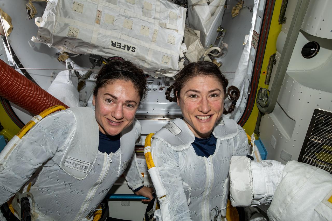 NASA astronauts Jessica Meir (left) and Christina Koch (right) put on their spacesuits as they prepare to leave the hatch of the International Space Station and begin the historical first-ever all-female spacewalk. The two ventured outside the International Space Station on Friday, Oct. 18, to replace faulty equipment on the station’s exterior. The astronauts replaced a faulty battery charge/discharge unit (BCDU) that failed to activate following the Oct. 11 installation of new lithium-ion batteries on the space station’s exterior structure. The BCDUs regulate the amount of charge put into the batteries that collect energy from the station’s solar arrays to power station systems during periods when the station orbits during nighttime passes around Earth. Though the BCDU failure has not impacted station operations or crew safety, it does prevent the new batteries from providing increased station power.