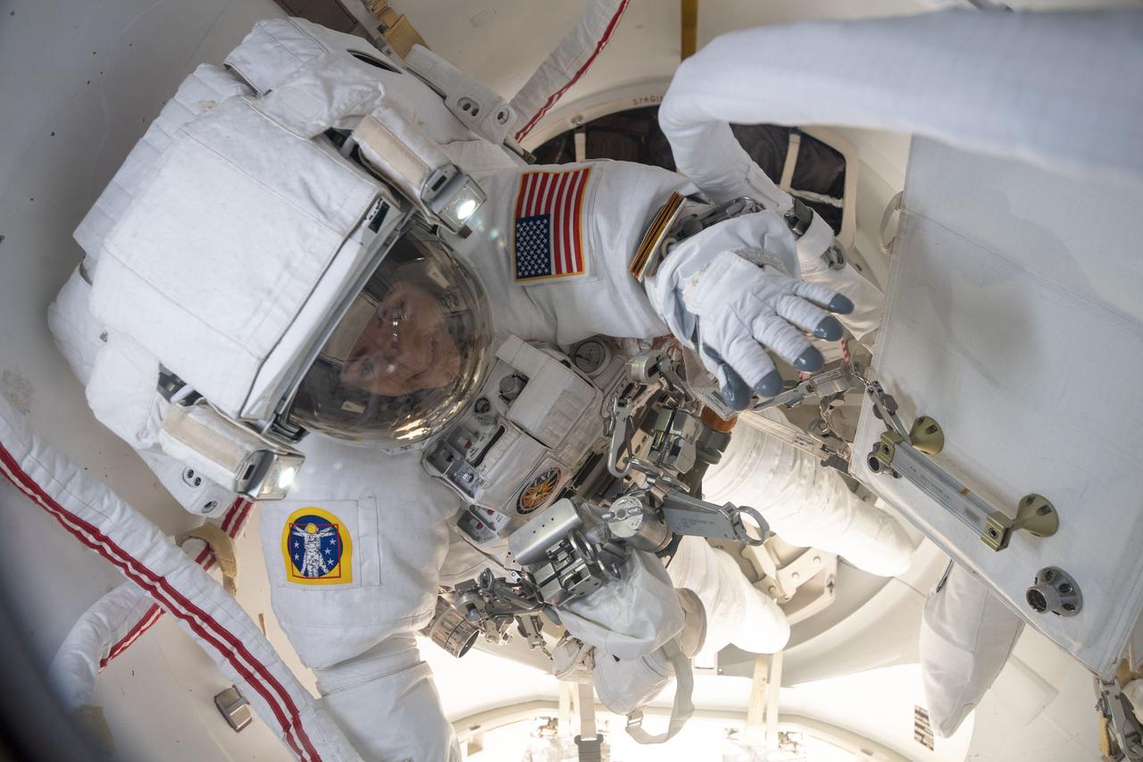 iss061e007080 (Oct. 18, 2019) --- NASA astronaut Jessica Meir is inside the crew lock portion of the U.S. Quest airlock ready to begin her first spacewalk at the International Space Station. She and fellow NASA astronaut Christina Koch (out of frame) would venture into the vacuum of space for seven hours and 17 minutes to swap a failed battery charge-discharge unit (BCDU) with a spare during the first all-woman spacewalk. The BCDU regulates the charge to the batteries that collect and distribute solar power to the orbiting lab’s systems.