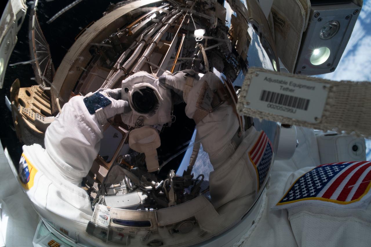 iss061e011750 (Oct. 18, 2019) --- NASA astronaut Jessica Meir takes an out-of-this-world "space-selfie" with her spacesuit helmet visor down reflecting her camera and International Space Station hardware. She and fellow NASA astronaut Christina Koch (out of frame) ventured into the vacuum of space for seven hours and 17 minutes to swap a failed battery charge-discharge unit (BCDU) with a spare during the first all-woman spacewalk. The BCDU regulates the charge to the batteries that collect and distribute solar power to the orbiting lab’s systems.