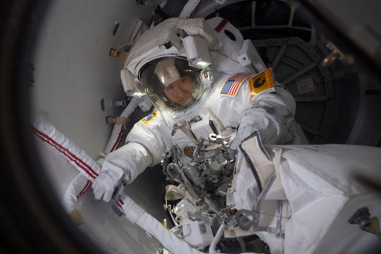 iss061e011934 (Oct. 18, 2019) --- NASA astronaut Christina Koch prepares to exit the crew lock portion of the Quest airlock into the vacuum of space. She and fellow NASA astronaut Jessica Meir (out of frame) conducted a spacewalk for seven hours and 17 minutes to swap a failed battery charge-discharge unit (BCDU) with a spare during the first all-woman spacewalk. The BCDU regulates the charge to the batteries that collect and distribute solar power to the orbiting lab’s systems.