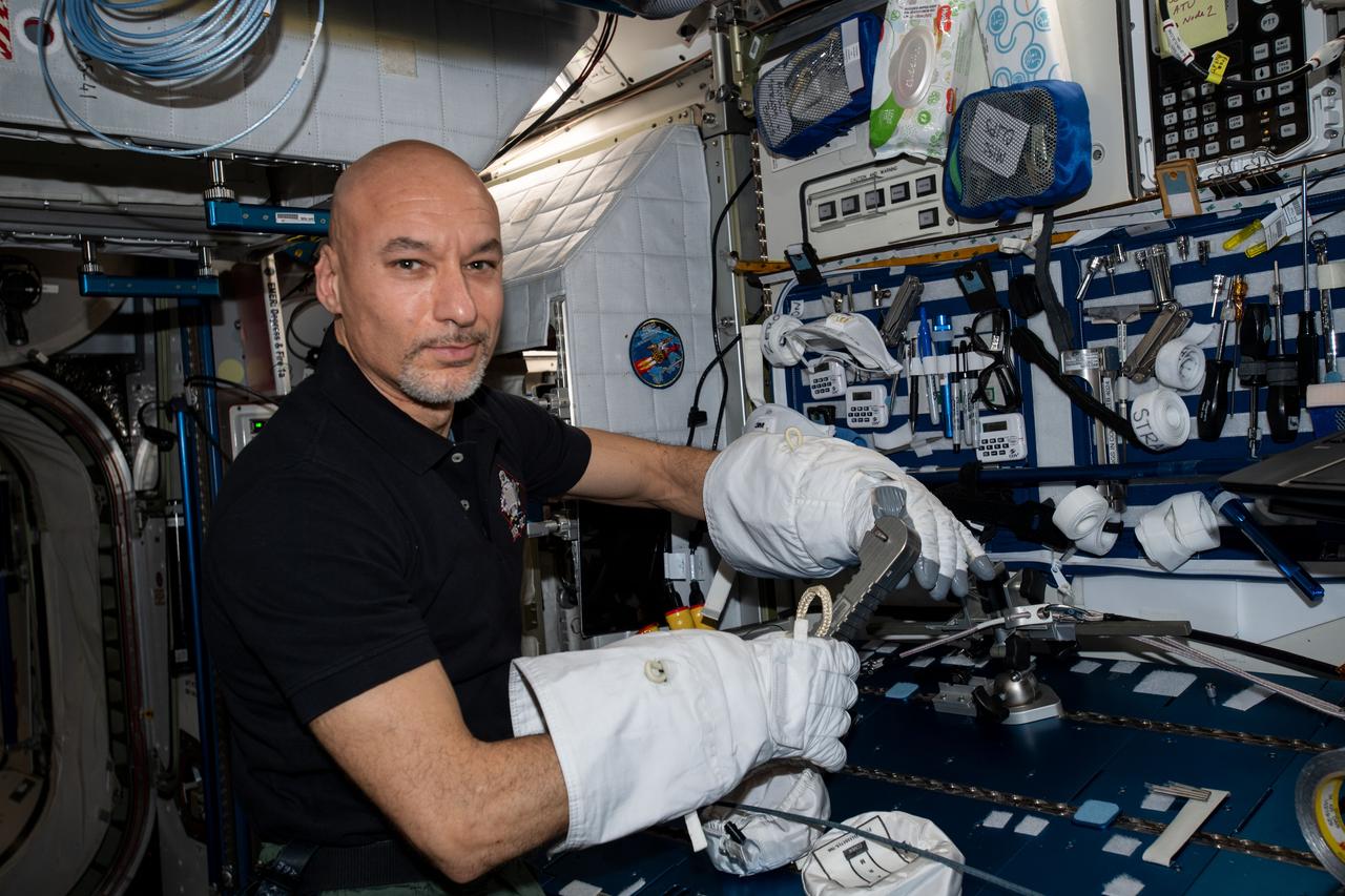 iss061e038284 (Nov. 12, 2019) --- ESA (European Space Agency) astronaut Luca Parmitano tests the usage of specialized spacewalking tools while wearing U.S. spacesuit gloves. The tools were designed specifically for the complex repair work planned for the International Space Station's cosmic particle detector, the Alpha Magnetic Spectrometer.