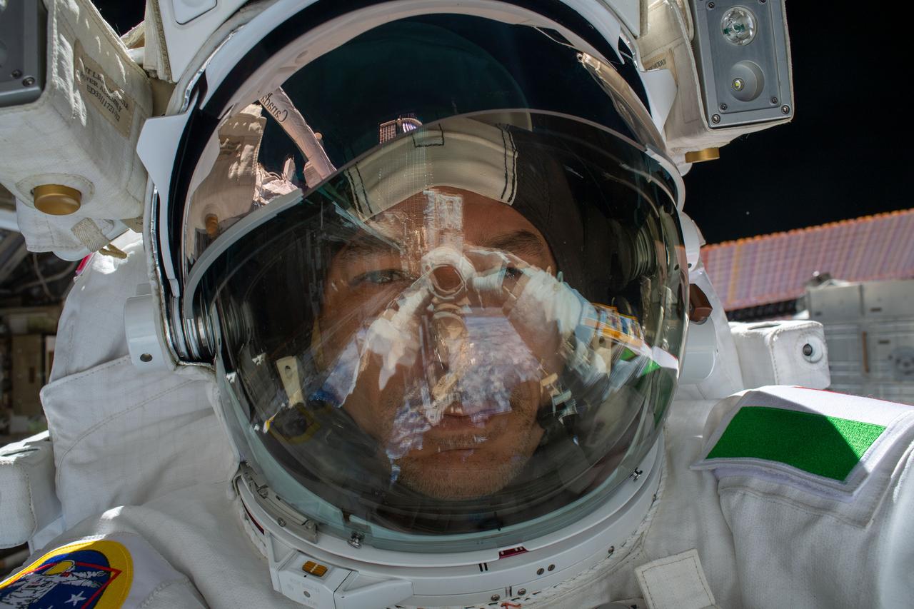iss061e040949 (Nov. 15, 2019) --- ESA (European Space Agency) astronaut Luca Parmitano takes an out-of-this-world "space-selfie" with his spacesuit's helmet visor up during the first spacewalk to repair the Alpha Magnetic Spectrometer, the International Space Station's cosmic particle detector.