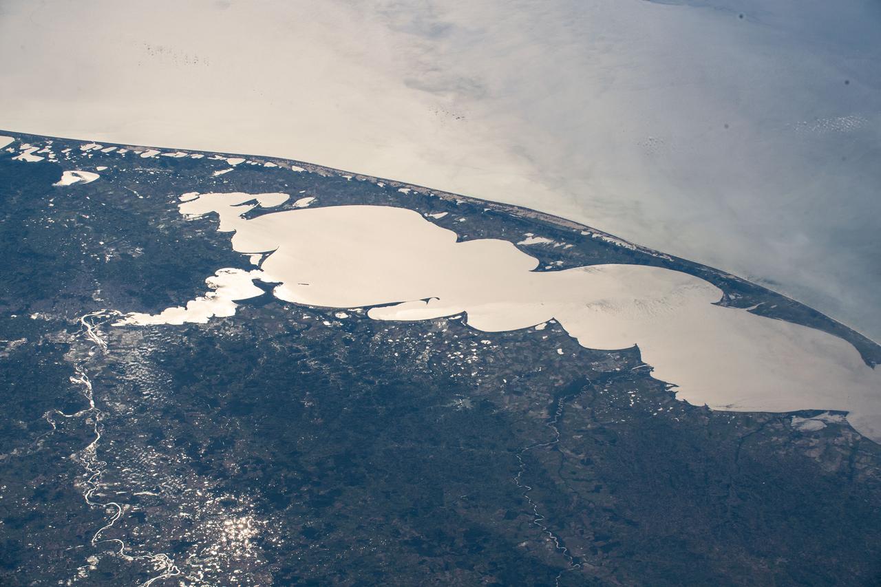 iss061e048125 (Nov. 19, 2019) --- The Sun's glint beaming off Brazil's largest lagoon, Lagos dos Patos, on the nation's southernmost tip is pictured from an altitude of 260 miles as the International Space Station orbited across the South American continent's Atlantic coast.