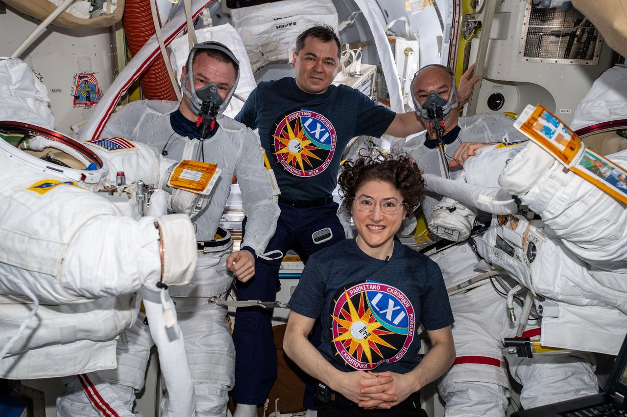 iss061e054283 (Nov. 22, 2019) --- Flight Engineers Christina Koch and Oleg Skripochka are pictured assisting spacewalkers Andrew Morgan (left) and Luca Parmitano (right) in the U.S. Quest airlock before they would begin the second spacewalk to repair the Alpha Magnetic Spectrometer's thermal control system.