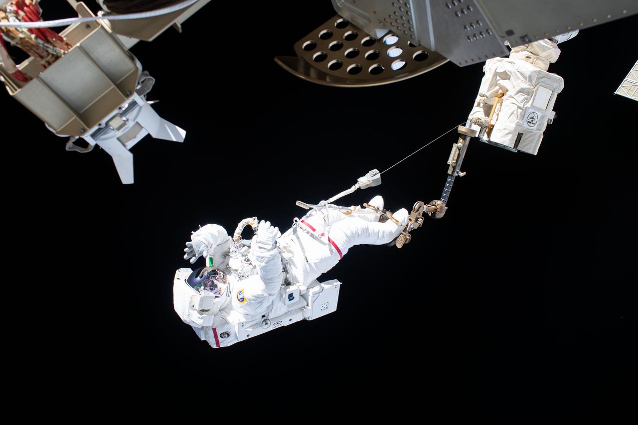 iss061e058498 (Nov. 22, 2019) --- Astronaut Luca Parmitano of ESA (European Space Agency) is attached to an articulating portable foot restraint at the end of the Canadarm2 robotic arm during the second spacewalk to repair the International Space Station's cosmic particle detector, the Alpha Magnetic Spectrometer.