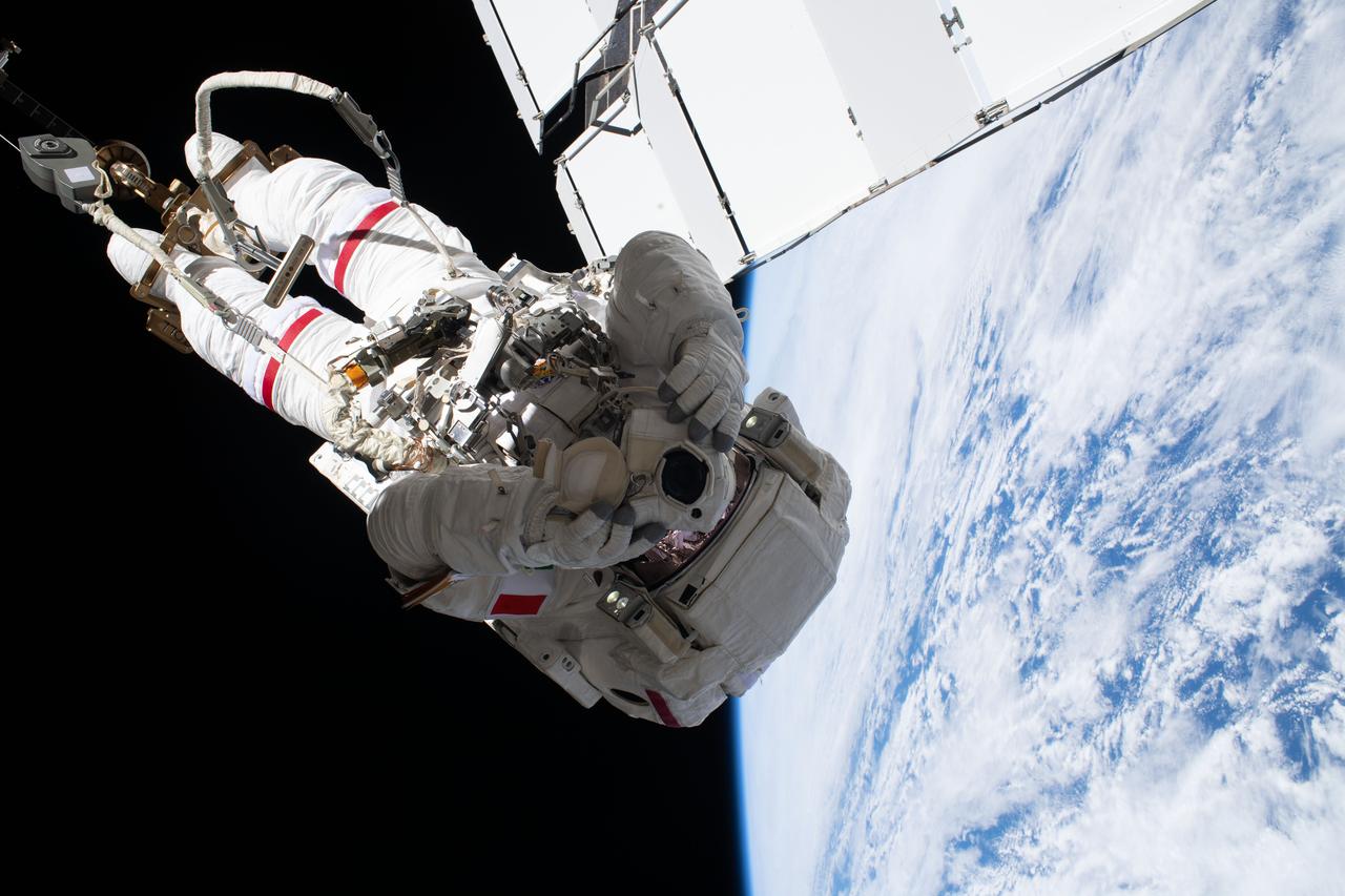 iss061e058522 (Nov. 22, 2019) --- Astronaut and spacewalker Luca Parmitano of ESA (European Space Agency) soars 250 miles above the Earth's surface attached to an articulated portable foot restraint, connected to the tip of the Canadarm2 robotic arm. He and fellow astronaut Andrew Morgan (out of frame) were conducting the second spacewalk to repair the International Space Station's cosmic particle detector, the Alpha Magnetic Spectrometer.