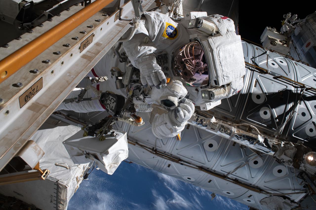 iss061e058754 (Nov. 22, 2019) --- Astronaut Luca Parmitano of ESA (European Space Agency) is pictured holding a camera protected from the hazards of microgravity by shielding during the second spacewalk to repair the International Space Station's cosmic particle detector, the Alpha Magnetic Spectrometer.