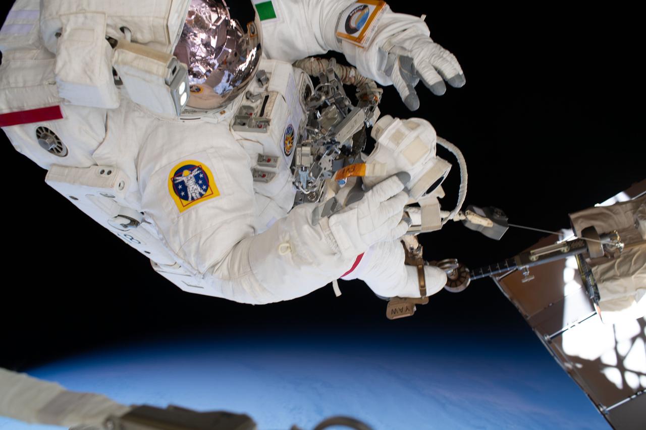 iss061e064936 (Dec. 2, 2019) --- ESA (European Space Agency) astronaut Luca Parmitano rides on the end of the Canadarm2 robotic arm attached to an articulating portable foot restraint during the third spacewalk to upgrade the Alpha Magnetic Spectrometer's thermal pump system.