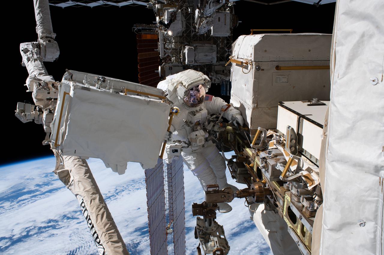 iss061e065379 (Dec. 2, 2019) --- NASA astronaut Andrew Morgan is tethered to the International Space Station with the Earth 250 miles below during the third spacewalk to upgrade the Alpha Magnetic Spectrometer's thermal pump system.