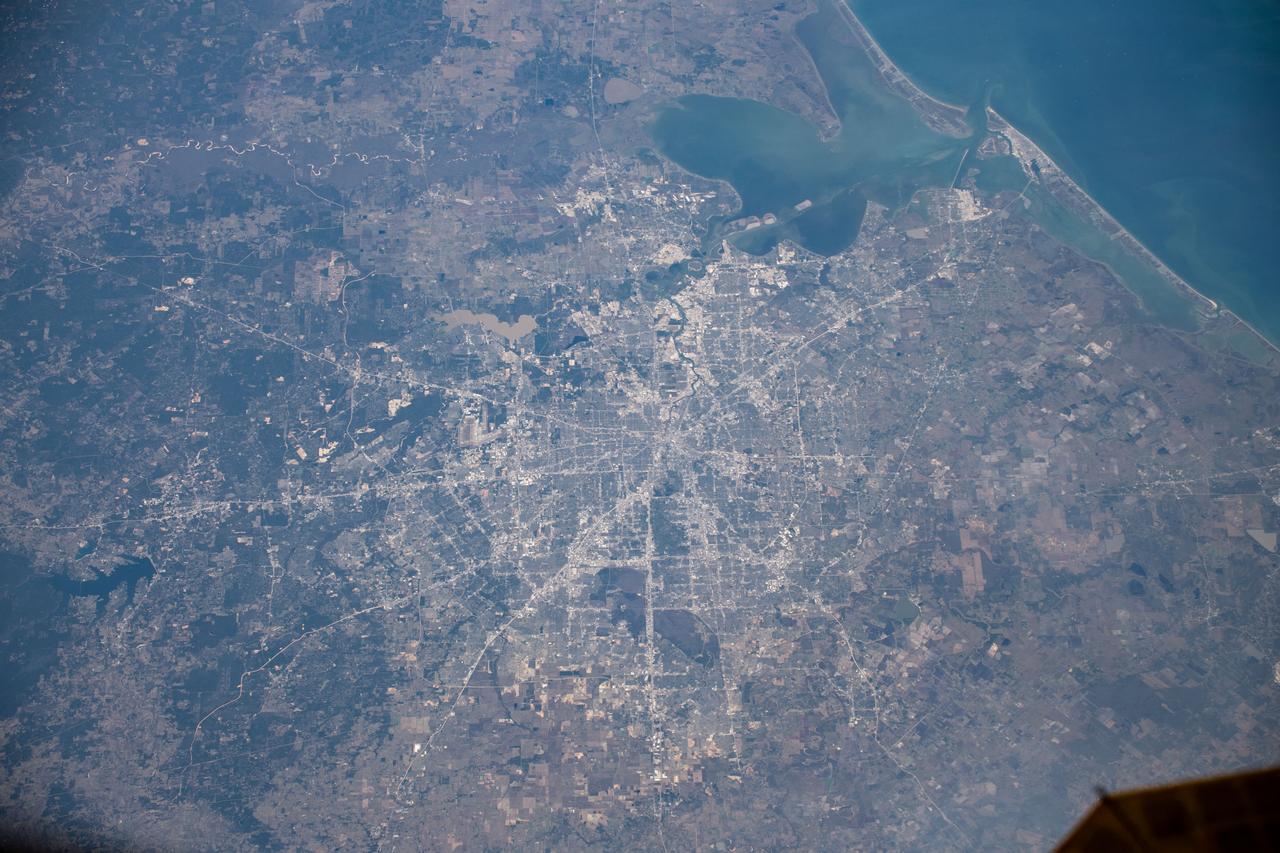 iss061e066680 (Dec. 3, 2019) --- Houston, Texas and its surrounding suburbs, including the island city of Galveston at the entrance of Galveston Bay at top right, is pictured from the International Space Station at an altitude of 257 miles.