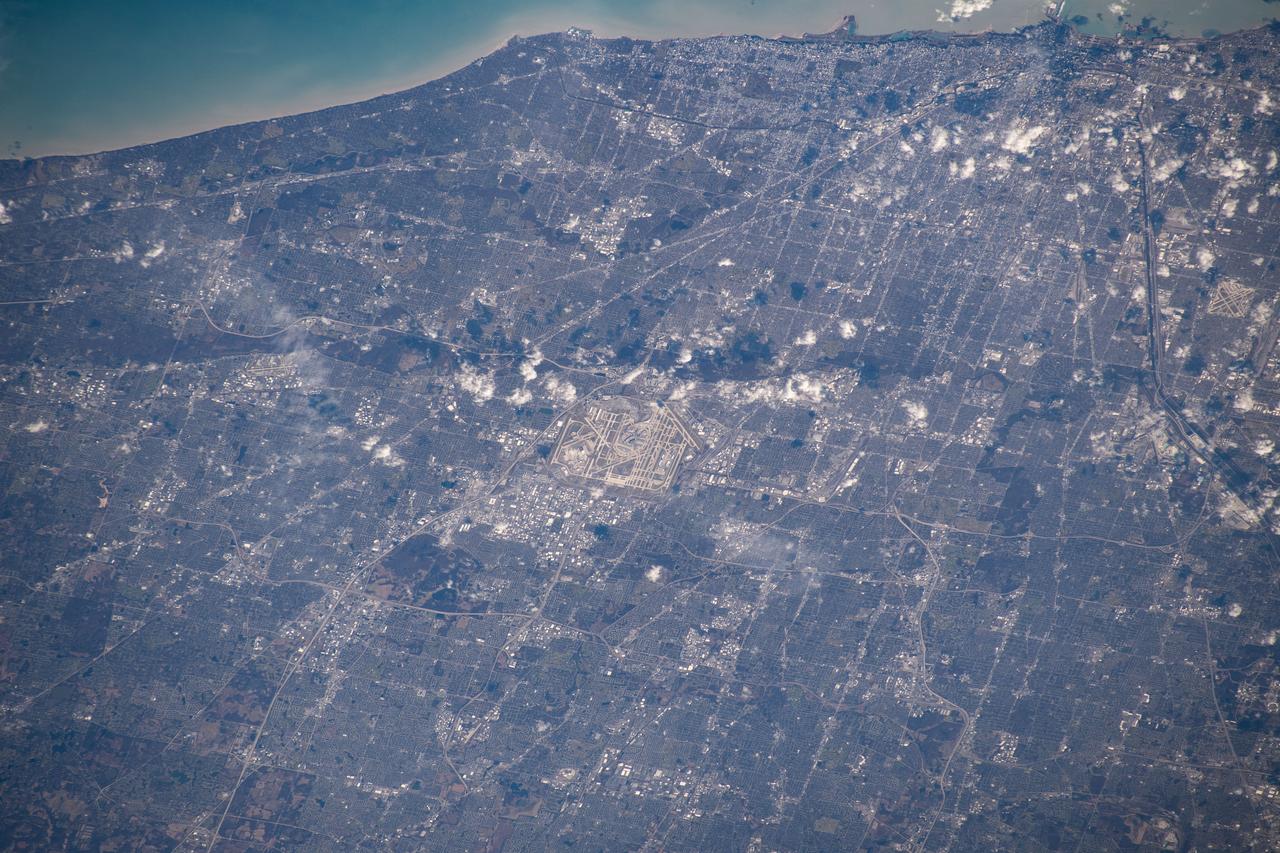 iss061e067911 (Dec. 6, 2019) --- Chicago's O'Hare International Airport is centered in this photograph with the Windy City's downtown at the top right corner on the coast of Lake Michigan. The International Space Station was orbiting 259 miles above the state of Illinois when this picture was taken.