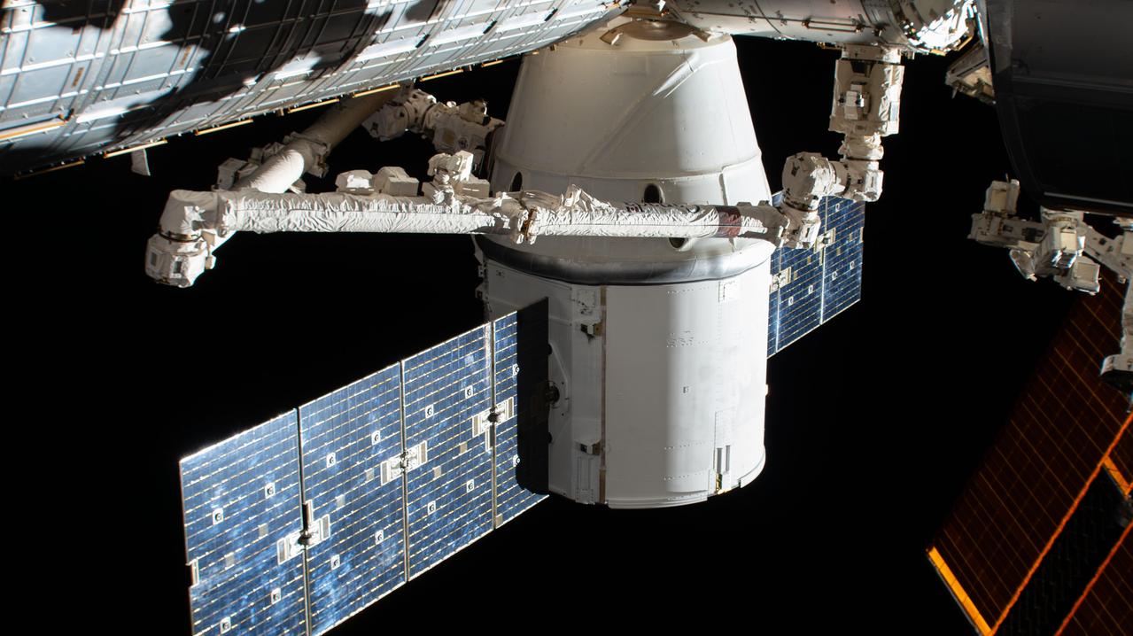 iss061e067992 (Dec. 8, 2019) --- The SpaceX Dragon resupply ship is pictured in the grip of the Canadarm2 robotic arm after it was installed to the Harmony module. The International Space Station was orbiting 262 miles above the North Pacific Ocean when this photograph was taken by an external high definition camera.