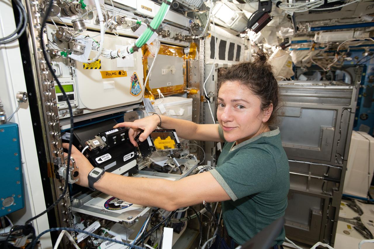 iss061e068057 (Dec. 9, 2019) --- NASA astronaut and Expedition 61 Flight Engineer Jessica Meir installs the Bone Densitometer in an EXPRESS (EXpedite the PRocessing of Experiments to Space Station) rack located inside the Japanese Kibo laboratory module. The Bone Densitometer enables the imaging of rodent bones for the Rodent Research-19 experiment that is investigating two proteins that may prevent muscle and bone loss in space.