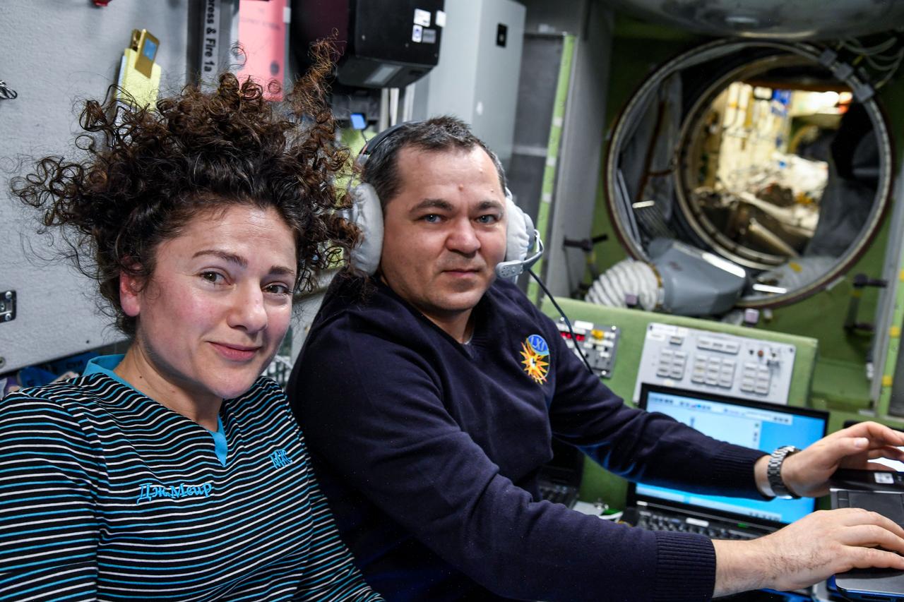 iss061e093210 (Dec. 19, 2019) --- NASA astronaut Jessica Meir and Roscosmos cosmonaut Oleg Skripochka, both Expedition 61 Flight Engineers, pose for a portrait inside the International Space Station's Zvezda service module.