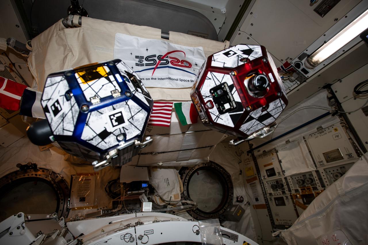 iss061e112435 (Dec, 31, 2019) --- A pair of tiny, free-floating satellites, also known as SPHERES (Synchronized Position Hold, Engage, Reorient, Experimental Satellites), are pictured during a session testing formation flying using algorithms programmed in to the bowling-ball sized devices.