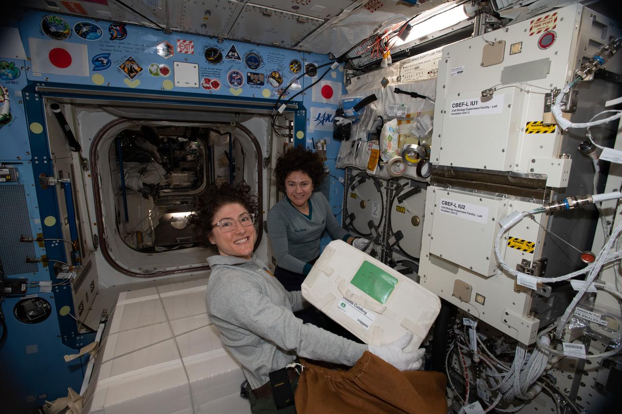 iss061e120292 (Jan. 6, 2020) --- NASA astronauts (from left) Christina Koch and Jessica Meir work inside the Kibo laboratory module collecting cold bags containing biological samples for stowage inside the SpaceX Dragon resupply ship. Dragon parachuted to a splashdown in the Pacific Ocean the following day on Jan. 7, 2020.