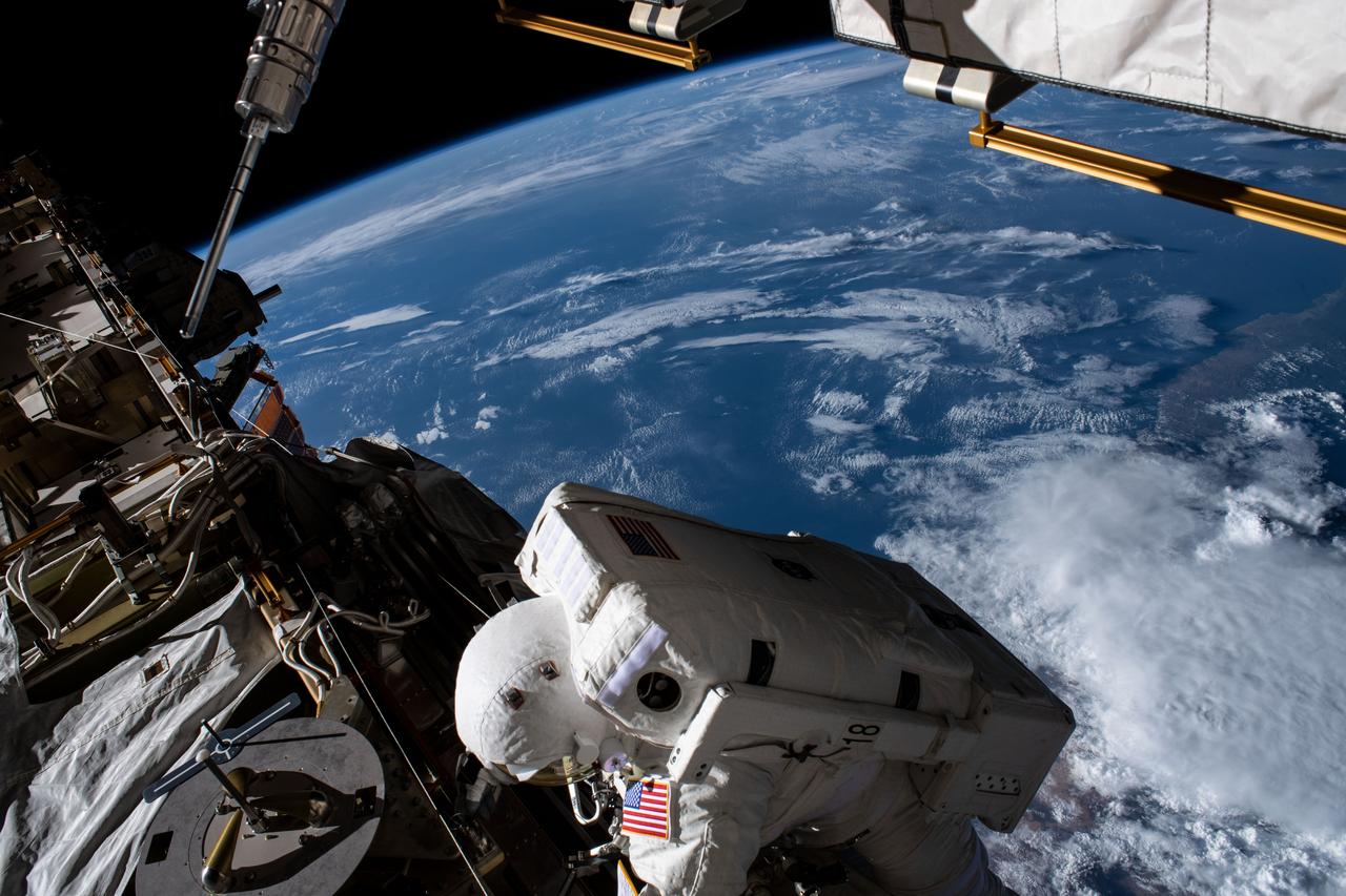 iss061e129986 (Jan. 15, 2020) --- NASA astronaut Christina Koch is pictured working in the vacuum of space 265 miles above the Atlantic Ocean off the coast of Africa. She and NASA astronaut Jessica Meir (out of frame) conducted a spacewalk to install new lithium-ion batteries that store and distribute power collected from solar arrays on the station’s Port-6 truss structure.