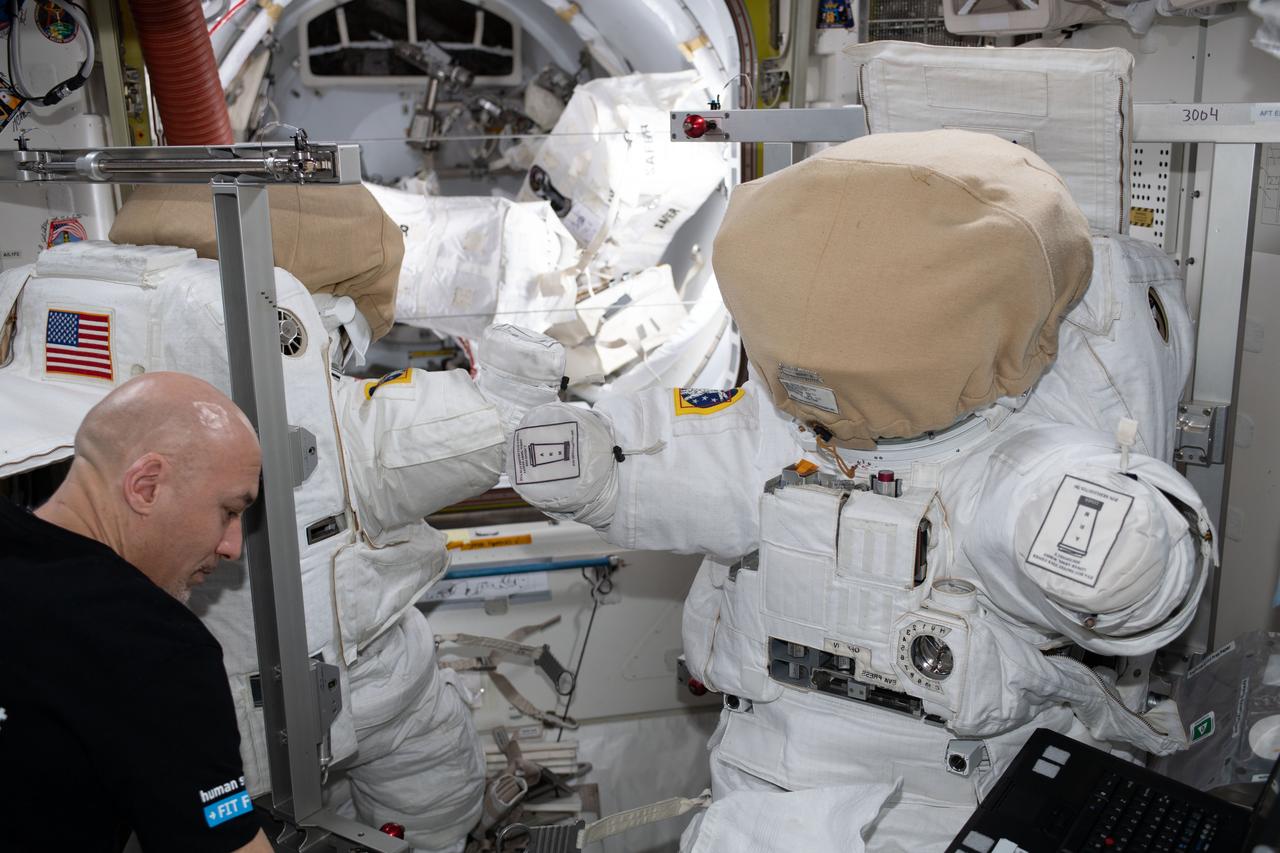 iss061e138059 (Jan. 21, 2020) --- Commander Luca Parmitano of ESA (European Space Agency) works on U.S. spacesuits that he and NASA astronaut Andrew Morgan will wear on a spacewalk scheduled for Jan. 25. The duo will finalize thermal repairs on the Alpha Magnetic Spectrometer, an astrophysics device searching for evidence of dark matter and antimatter on the International Space Station's Starboard-3 truss structure.