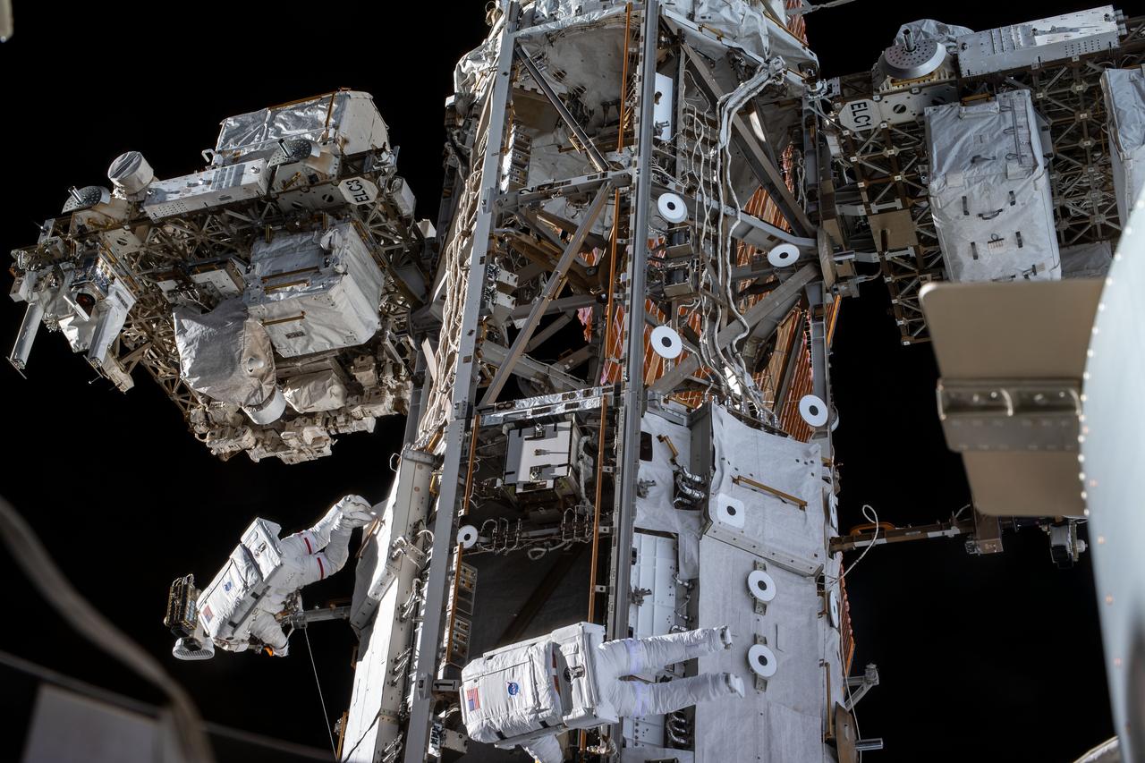 iss061e142328 (1/25/2020) --- A view of NASA astronaut Andrew Morgan and European Space Agency (ESA) astronaut Luca Parmitano during EVA-64 abroad the International Space Station (ISS). The Space Test Program-Houston 6 (STP-H6) payload, can be seen atop of the EXPRESS Logistics Carrier-3 (ELC-3) at the far left of the image.