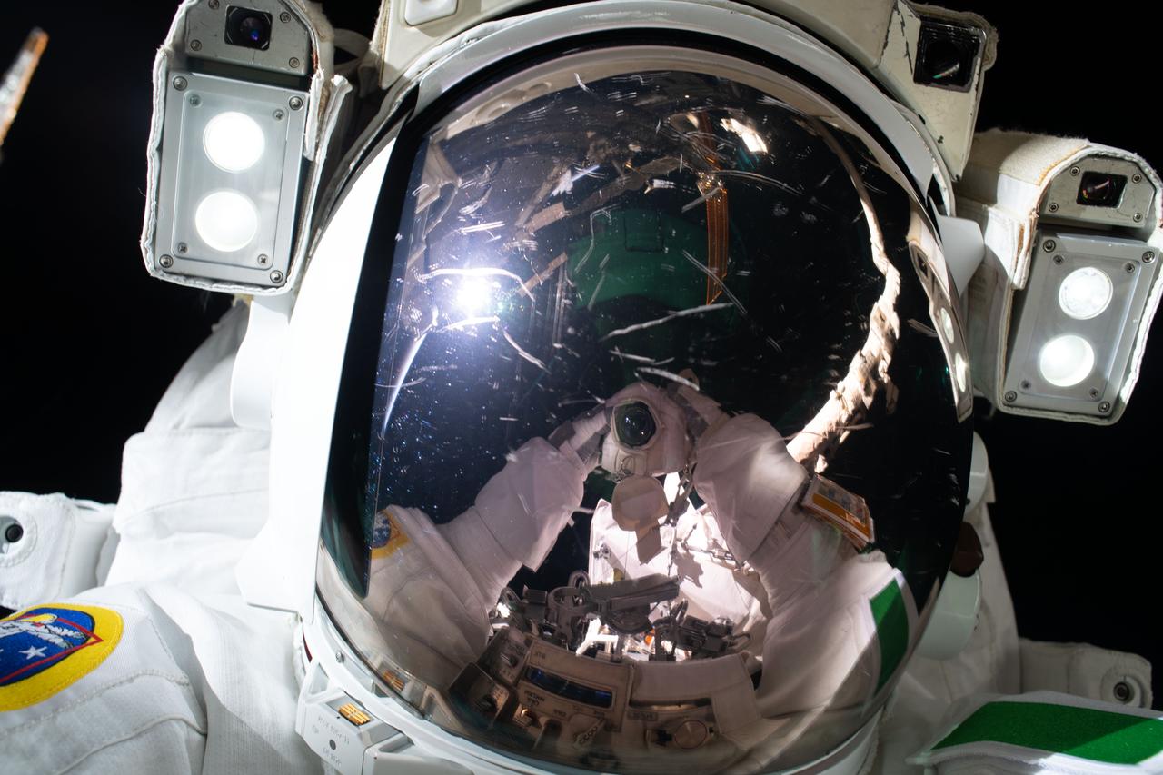 iss061e144502 (Jan. 25, 2020) --- ESA (European Space Agency) astronaut Luca Parmitano takes a "space-selfie" with his camera's reflection on his spacesuit's helmet visor. He and NASA astronaut Andrew Morgan were finalizing thermal repairs on the Alpha Magnetic Spectrometer, a dark matter and antimatter detector, during a spacewalk that lasted 6 hours and 16 minutes.