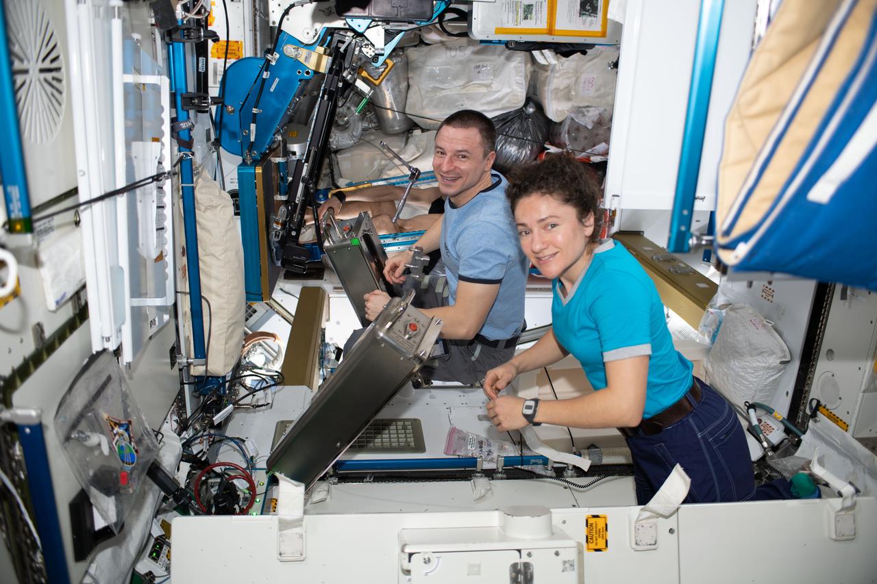 iss061e144870 (Jan. 26, 2020) --- NASA astronauts Jessica Meir and Andrew Morgan, both Expedition 61 Flight Engineers, work on orbital plumbing tasks inside the Waste and Hygiene Compartment aboard the International Space Station's Tranquility module.