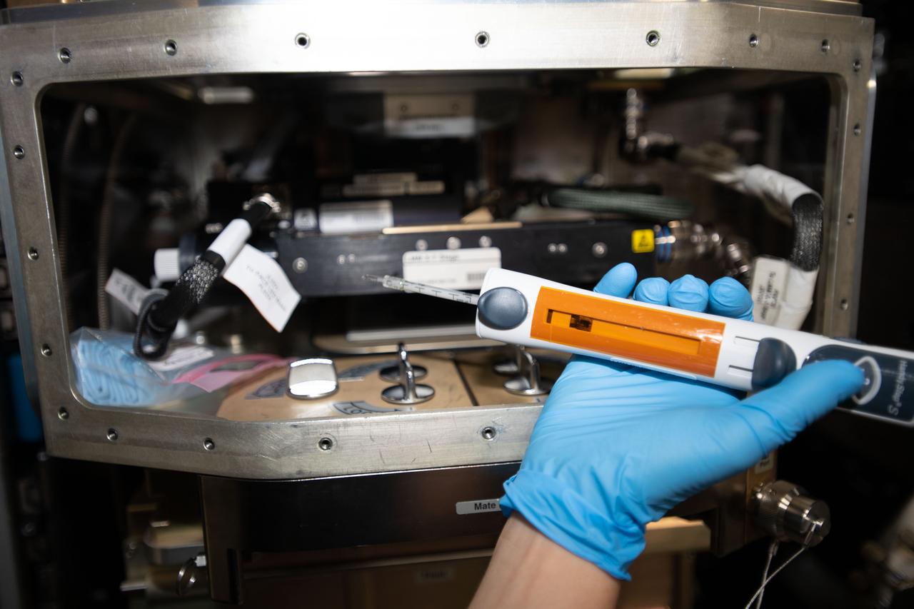 iss062e014342 (2-16-2020) --- A view of NASA astronaut Jessica Meir configuring the Light Microscopy Module (LMM) for the Advanced Colloids Experiment-Temperature-4 (ACE-T-4) science run in the Destiny module aboard the International Space Station (ISS). Introducing disorder to a crystalline system in a controlled way can form glass. Advanced Colloids Experiment-Temperature-4 (ACE-T-4) examines the transition of an ordered crystal to a disordered glass to determine how increasing disorder affects structural and dynamic properties