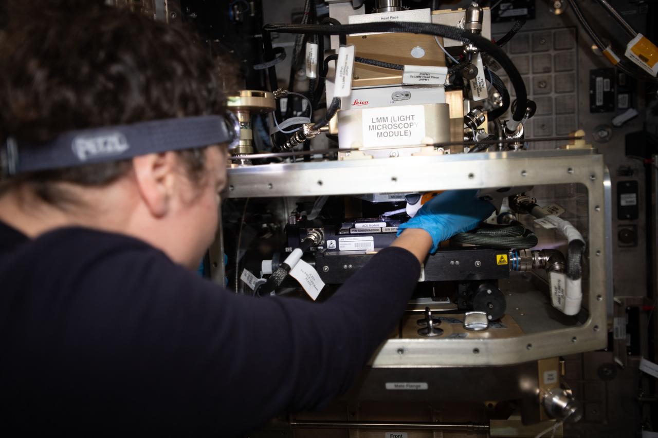iss062e014345 (2-16-2020) --- A view of NASA astronaut Jessica Meir configuring the Light Microscopy Module (LMM) for the Advanced Colloids Experiment-Temperature-4 (ACE-T-4) science run in the Destiny module aboard the International Space Station (ISS). Introducing disorder to a crystalline system in a controlled way can form glass. Advanced Colloids Experiment-Temperature-4 (ACE-T-4) examines the transition of an ordered crystal to a disordered glass to determine how increasing disorder affects structural and dynamic properties