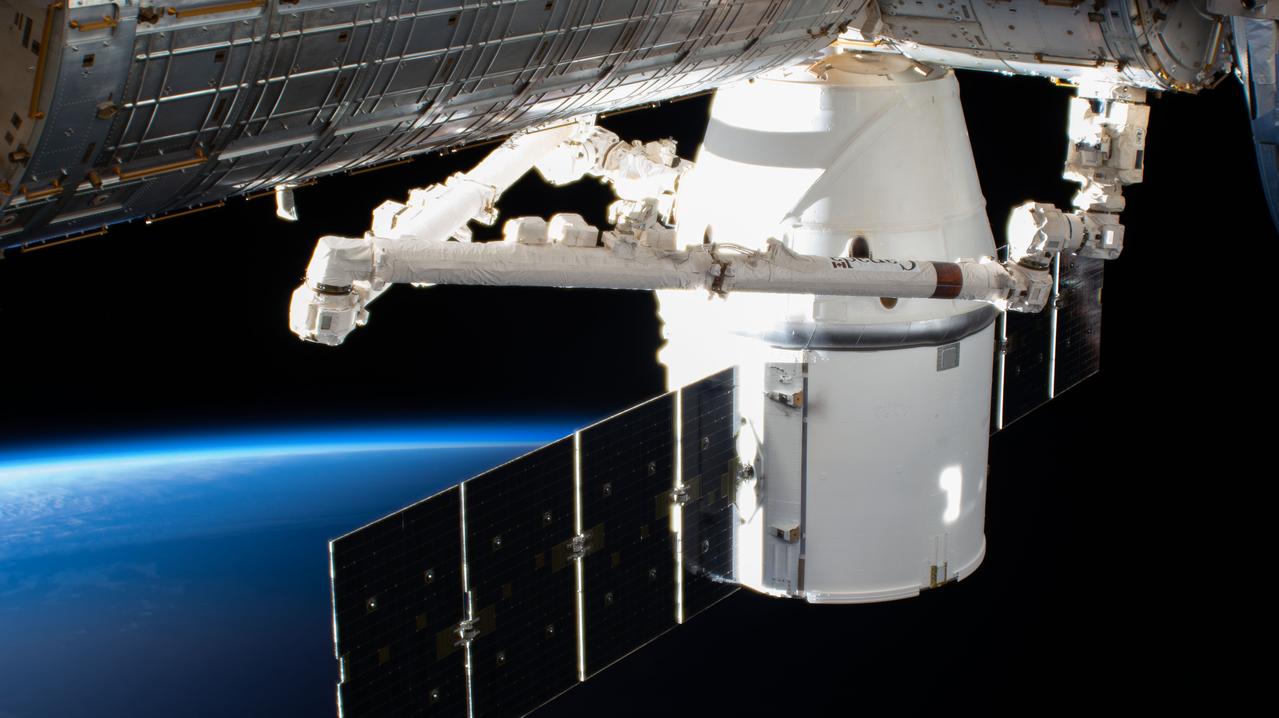 iss062e087409 (March 9, 2020) --- The SpaceX Dragon resupply ship is pictured attached to the International Space Station's Harmony module as both spacecraft were soaring into an orbital sunrise 264 miles above the American state of Nevada.