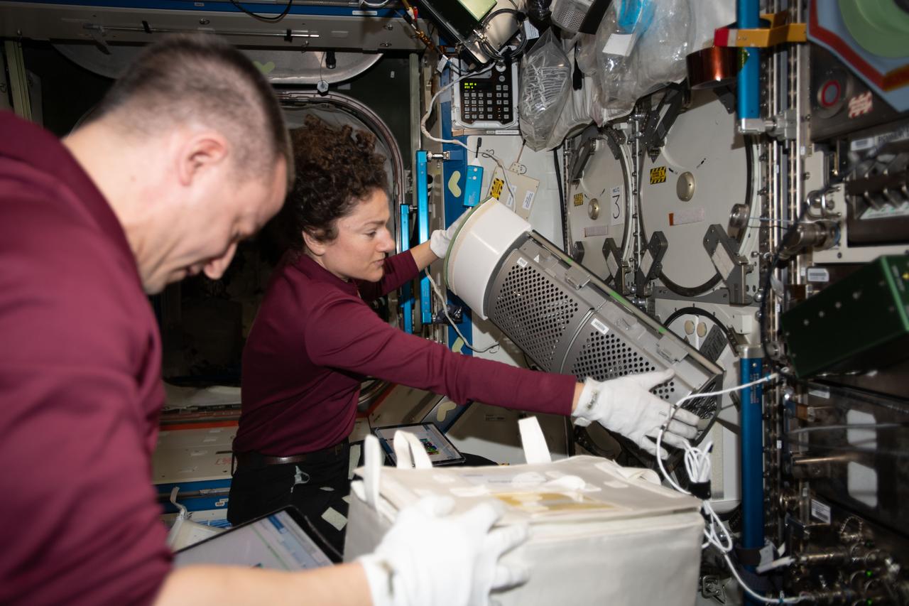 iss062e123483 (April 5, 2020) --- NASA astronauts and Expedition 62 Flight Engineers Andrew Morgan and Jessica Meir collect frozen research samples for loading into the SpaceX Dragon resupply ship. Dragon returned to Earth the following day, splashing down in the Pacific Ocean packed with over 4,000 pounds of science experiments and station hardware for analysis.
