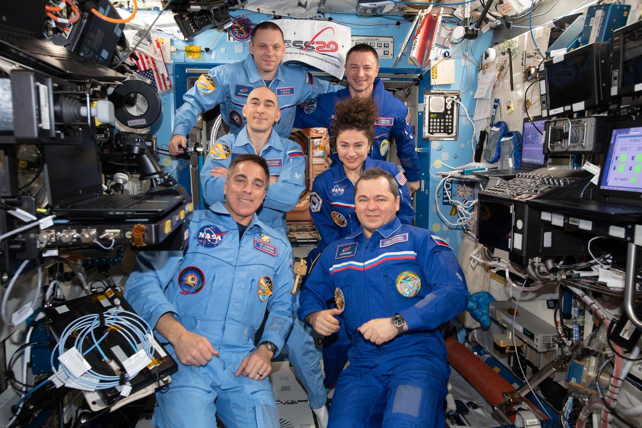 iss062e150159 (March 15, 2020) --- The Expedition 62 and 63 crews pose together moments after Roscosmos cosmonaut Oleg Skripochka (bottom right) handed over station command to NASA astronaut Chris Cassidy (bottom left). On the right side, are Expedition 62 crewmembers Skripochka with NASA astronauts Jessica Meir and Andrew Morgan. On the left, are Expedition 63 crewmembers Cassidy with Roscosmos cosmonauts Anatoly Ivanishin and Ivan Vagner. The Expedition 62 crew returned to Earth on April 17, 2020, at 1:16 a.m. EDT (11:16 a.m. Kazakh time)