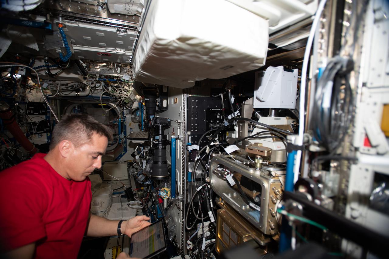 iss063e001782 (April 21, 2020) --- NASA astronaut and Expedition 63 Commander Chris Cassidy works on the Fluids Integrated Rack (FIR) replacing components in the research device that studies the behavior of fluids in microgravity. The FIR will help promote the design of advanced space-based fuel tanks and other complex fluid transfer systems.